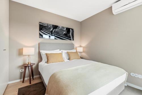 a bedroom with a large white bed in a room at 108MM House in Porto
