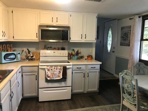 a kitchen with white cabinets and a stove top oven at Hope Bed and Breakfast in Canton