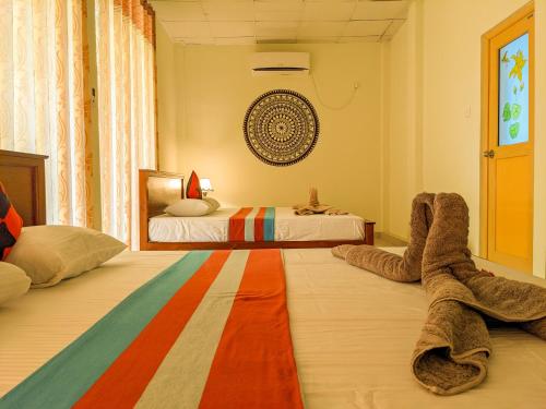 a bedroom with two beds and a rug on the floor at Sigiri Choona Lodge 'unique sunrise viewpoint' in Sigiriya