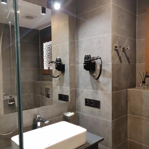 a bathroom with a sink and a shower at Hotel Zefir in Drohobytsch