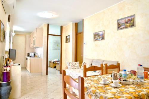 a kitchen and a living room with a table and a room at Hotel Diffuso Il Portichetto sulla collina a Vezio Perledo in Perledo