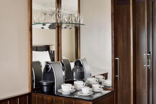 a room with a table with cups and a mirror at InterContinental Bahrain by IHG in Manama