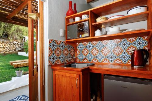 a kitchen with wooden cabinets and a sink and a window at Rus In De Rust in De Rust