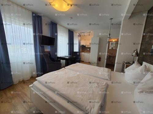 a room with a bed and a desk in it at Haus Achtern Diek in erster Reihe am Meer in Fehmarn