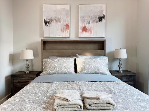 a bedroom with a bed with two lamps and towels on it at Stay at Luna on Ridge Ave in Philadelphia