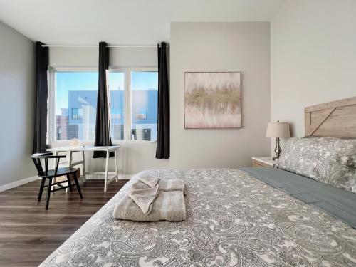 a bedroom with a bed and a desk and windows at Stay at Luna on Ridge Ave in Philadelphia