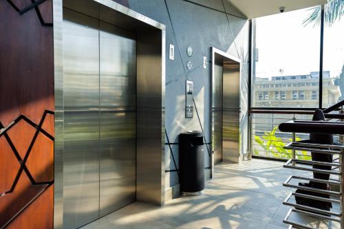 an elevator in a building with a trash can at Crowne Plaza - Dar Es Salaam by IHG in Dar es Salaam