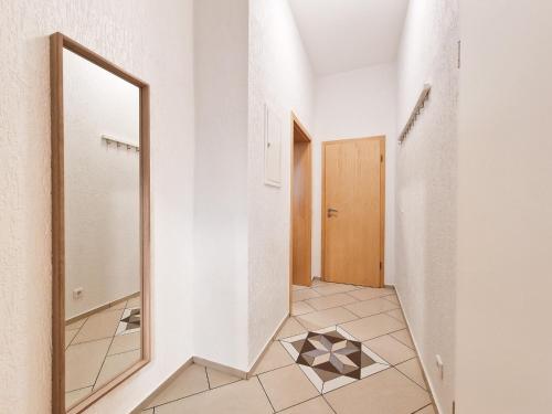 een hal met een spiegel en een tegelvloer bij RAJ Living - 2 , 3 and 4 Room Apartments - 25 Min Messe DUS in Duisburg