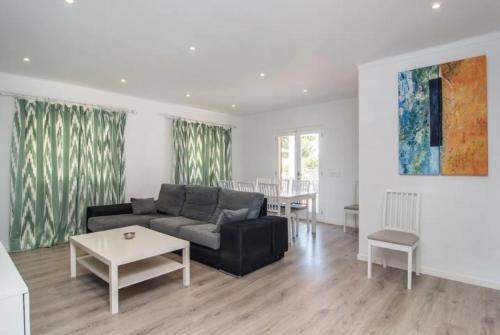 a living room with a couch and a table at Anglesos in Can Picafort
