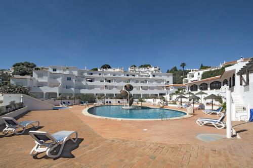 a resort with a swimming pool and white buildings at 413 Casa Marsalema in Salema