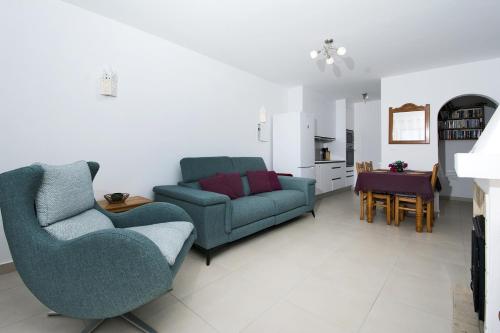 a living room with two chairs and a couch at 413 Casa Marsalema in Salema