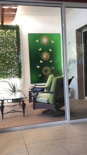 a reflection of a chair in a window at Casa Robyn in Cabo San Lucas