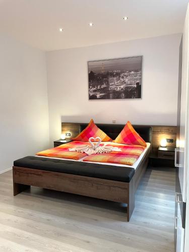 a bedroom with a large bed with colorful pillows at Hotel Martz in Pirmasens