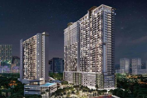two tall buildings in a city at night at Condo near Ayala Cebu City w Wifi Balcony in Cebu City