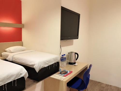 Postel nebo postele na pokoji v ubytování Tras Mutiara Hotel Bentong