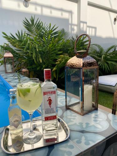 a table with a drink and a bottle of alcohol at Matisia Hotel Boutique in Guaduas