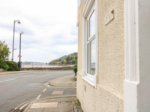 a building with a window on the side of a road at Gadlys House 62 in Beaumaris