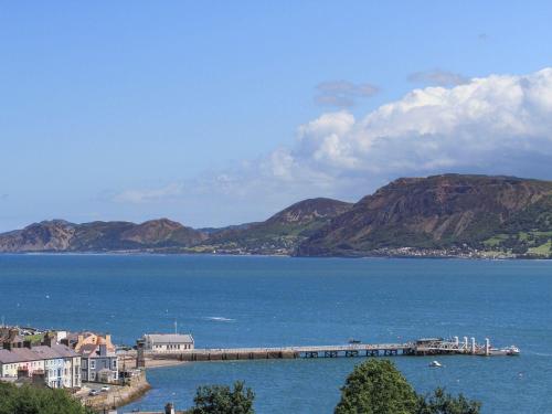 a view of a large body of water with mountains at Gadlys House 62 in Beaumaris