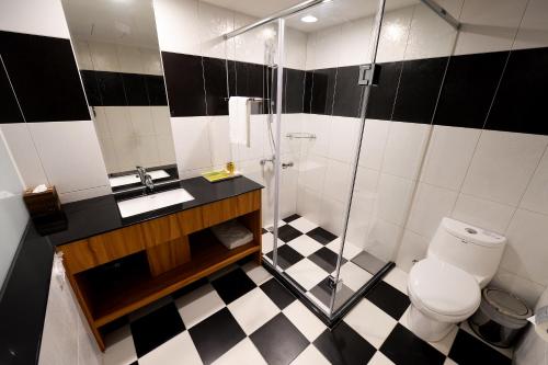 a bathroom with a shower and a toilet and a sink at Bamboo Hotel in Kaohsiung