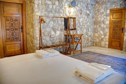 a bedroom with a bed with two towels on it at Ala Stone Hotel in Goreme