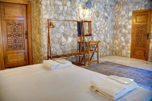 a bedroom with a bed with two towels on it at Ala Stone House in Goreme