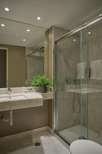 a bathroom with a shower and a sink at Hotel Dom Carlos Park in Lisbon