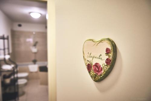 a heart shaped sign hanging on a wall at Affittacamere San Teodoro in Albenga