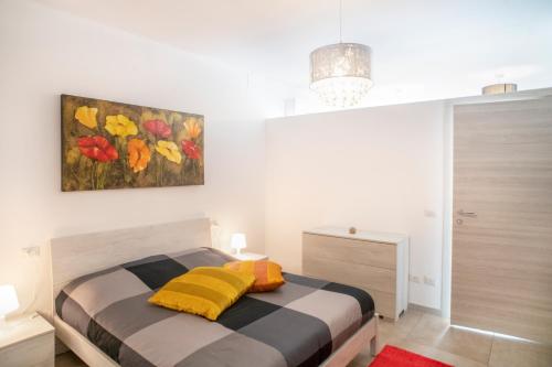 a bedroom with a bed and a painting on the wall at DiMora RIccaFrida - Luxury Home - in Prato