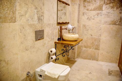 a bathroom with a toilet and a sink at Ala Stone House in Goreme
