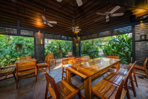 a dining room with wooden tables and chairs at Jet Luxury at Langosta Beach Resort & Villas in Tamarindo