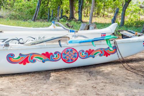 a white boat with a painting on the side of it at Jet Luxury at Langosta Beach Resort & Villas in Tamarindo