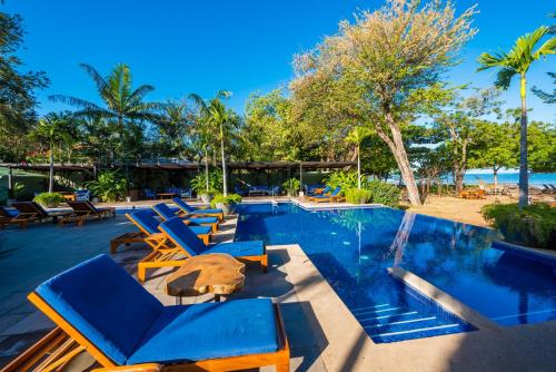 a swimming pool with lounge chairs and a resort at Jet Luxury at Langosta Beach Resort & Villas in Tamarindo