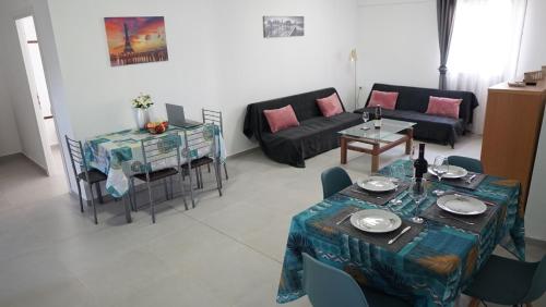 a living room with a couch and a table at Nikolas Family Apartments in Moírai