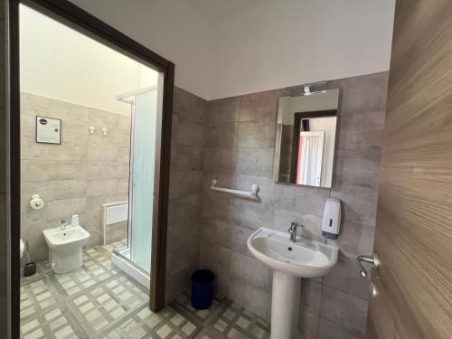 a bathroom with a sink and a toilet at Hostel Turin Metro Young in Turin