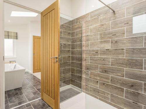 a bathroom with a walk in shower next to a toilet at 1 Horizon View in Liskeard