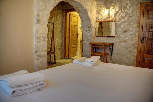 a bedroom with a bed with towels on it at Ala Stone Hotel in Goreme
