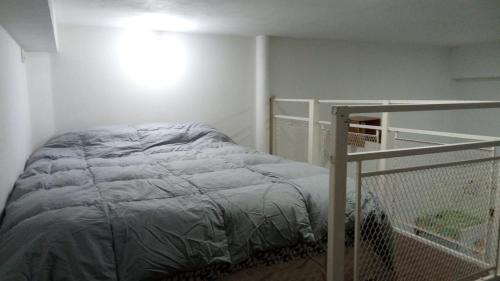 a small bedroom with a bed and a railing at Bless1 in Puerto Madryn