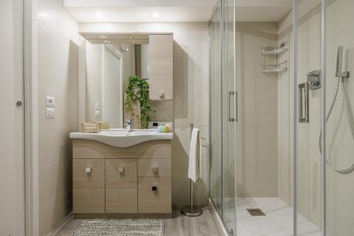 a bathroom with a sink and a shower at Siena Living Apartment in Siena