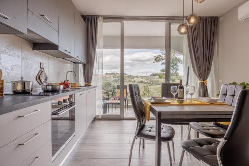 a kitchen with a table and chairs and a dining room at Siena Living Apartment in Siena