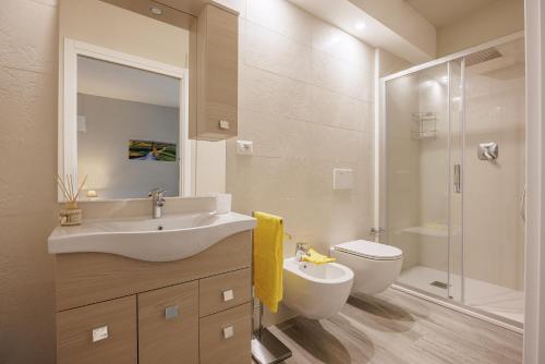 a bathroom with a sink and a toilet and a shower at Siena Living Apartment in Siena