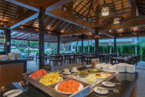 a buffet of food on a table in a restaurant at The Leaf Oceanside by Katathani - SHA Extra Plus in Khao Lak