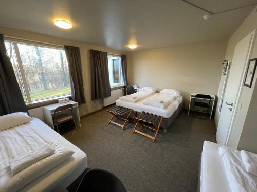 a hospital room with two beds and a window at Guesthouse Bitra B&B in Selfoss