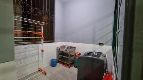 a small room with a machine in the corner at Kenyalang Emerald Riverine Resort Homestay in Kuching