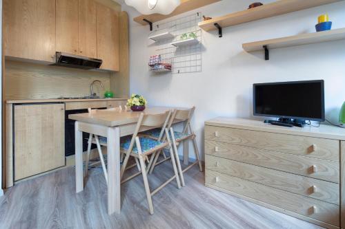 a small kitchen with a table and a tv at Condominio Escargot in Breuil-Cervinia