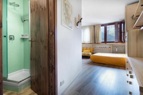 a bedroom with a bed and a glass shower at Condominio Escargot in Breuil-Cervinia