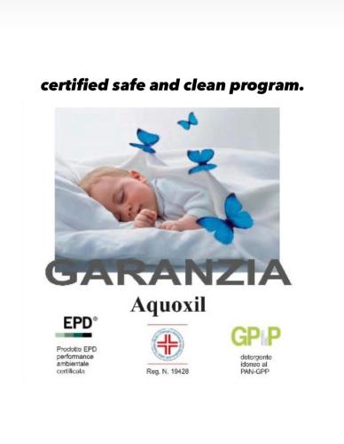 a baby sleeping on a bed with blue butterflies at Green House city center in Bologna