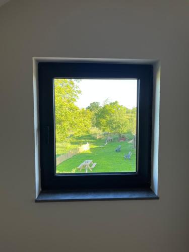 a picture of a window with a view of a park at De Hoogstam in Vijlen