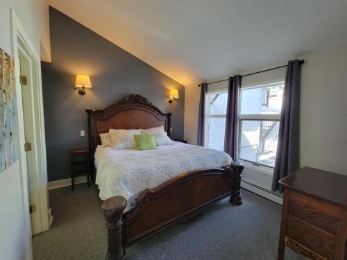 a bedroom with a large bed and a window at The Georgetown Inn in Canmore