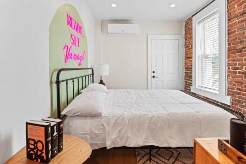 a bedroom with a bed and a surfboard on the wall at Urban Chic 1BR - Walk to Boardwalk - Min to Beach in Atlantic City