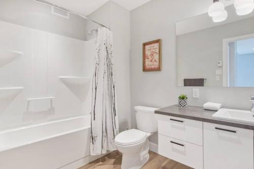a white bathroom with a toilet and a sink at Initial / Soeur No2 / MSA in Saint-Férréol-les-Neiges